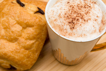 Light morning breakfast with croissant and coffee