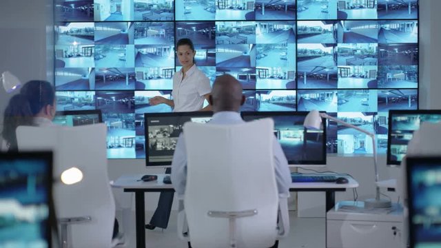  Security officer communicating with staff in observation control room