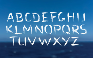 Fototapeta premium Brush Font Bold Letters on Sea Background