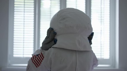 Young at heart elderly lady dressed as astronaut in her bedroom in a nursing home.