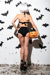 Back view image of pretty young woman in halloween costume