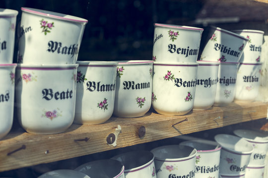 Coffee mugs behind a shop window.