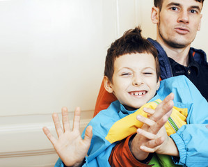 young handsome father with his son fooling around at home, lifes