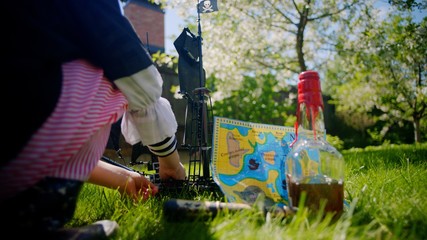 Naklejka premium Little boy wearing pirate costume is playing in toy ship of pirates of caribbean on the lawn on Halloween
