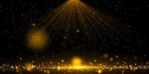Stage lights with sprinkle gold dust on a black background with copy space.	