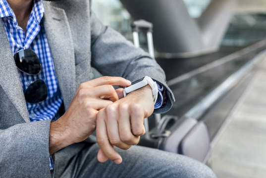 Close-up of businessman using his smartwatch in the city
