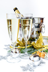 glasses of champagne and Christmas ornaments on white background