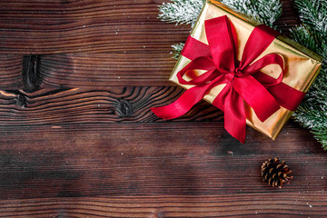 gifts boxes with fir branches on wooden background top view