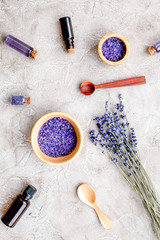 Obraz na płótnie Canvas Essential oil and lavender salt with flowers top view