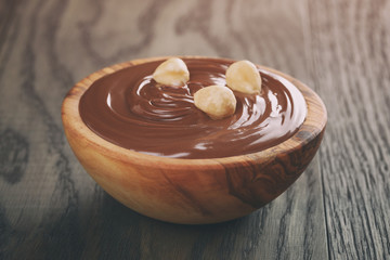 chocolate hazelnut creamin wood bowl, on old table