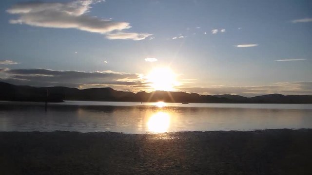 Sunset over the mountains in the background of the river in Laredo,Spain. Accelerated video. Timelapse. No sound.