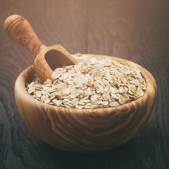 oat flakes in wood bowl on oak table