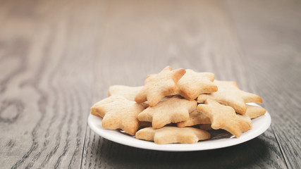 homemade star shape ginger cookies on wood table