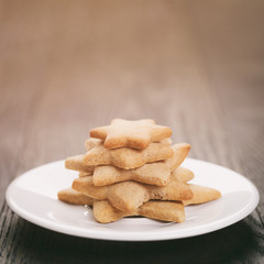 homemade star shape ginger cookies on wood table