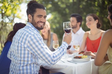 Man holding a wine glass in restaurant