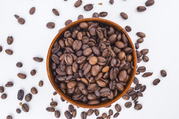 Concept roasted coffee beans in wooden bowl with isolated white background