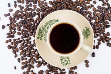 Concept roasted coffee beans and hot coffee with isolated white background