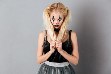 Portrait of a pretty blonde woman in halloween clown make-up
