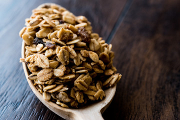 Granola and ingredients in wooden spoon