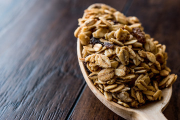 Granola and ingredients in wooden spoon