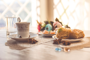 Cup of Turkish coffee and a plate with baklava