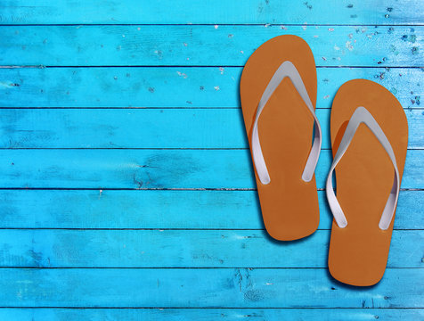 Two orange man lifestyle relax flip flops on blue wooden floor