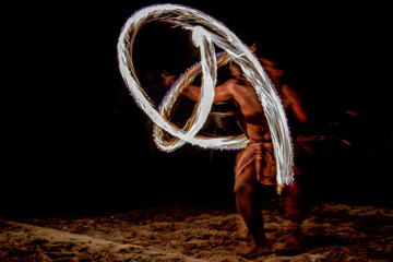 Fire dance Cook Islands polynesian dancer with pole of flames