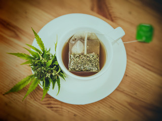 Cannabis tea from green leaf in cup, cannabis leaves tea bag,