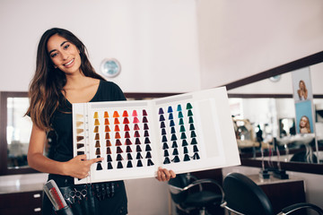 Hairdresser showing hair color shade card at salon © Jacob Lund