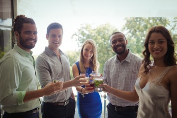 Group of friends toasting cocktail glasses