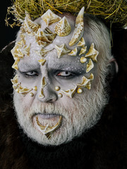 man or monster with thorns on face with futuristic makeup