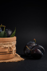 Garden plums in bowl on stone table