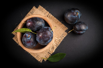 Garden plums in bowl on stone table