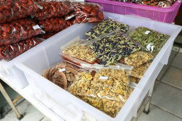 Dried butterfly pea and flower herb in bag in a container for sell at local shop at On Nut, Bangkok, Thailand