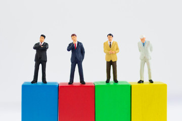 Miniature businessman :Graphs of various colors show the success of the work, Business teamwork concept.