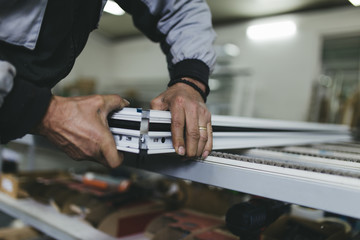 Manual worker assembling PVC doors and windows. Manufacturing jobs. Selective focus. Factory for aluminum and PVC windows and doors production.