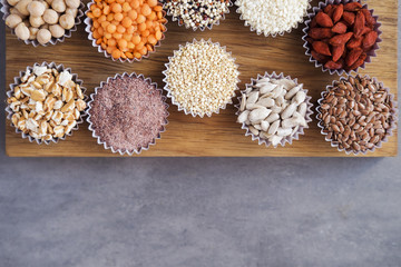 Various superfoods, seeds, cereals, grains on a gray background. Healthy eating concept. Top view