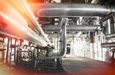 Equipment, cables and piping as found inside of a modern industrial power plant