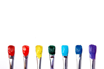 Paintbrushes with rainbow paints.