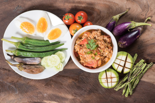 Thai Northern food (Nam Prik Ong) with vegetables on wooden background,spicy tomato with pork,red chili dip,Northern Thai dipping sauce