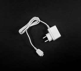 Old adapter Charger for smart phone on white background