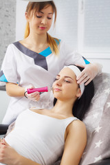 Woman having underarm Laser hair removal epilation