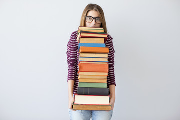 Student woman holding pile books - obrazy, fototapety, plakaty