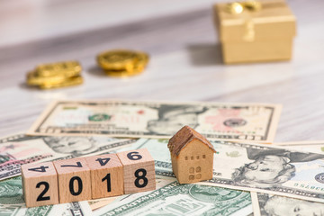 2018 new year cubes with the house model on group of cash and the gold gift