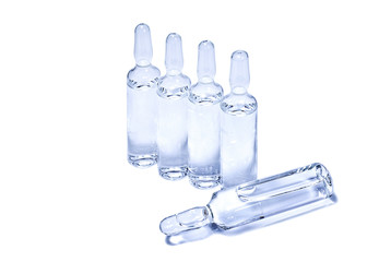 Ampules with transparent vaccine on white background