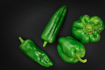 Organic Green bell pepper and Green paprika on black background with copy space 