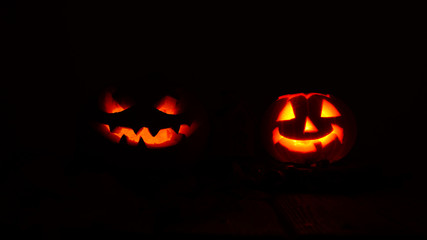 Creepy halloween pumpkins in the dark. Silhouette of pumpkin. Candle inside.