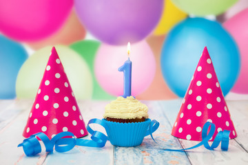 Cupcake decorated with candle and hats