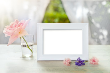 Picture frame mockup with rose in glass
