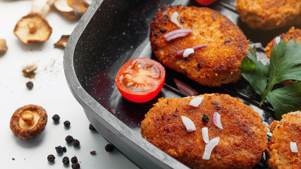 Homemade cutlets with fresh vegetables and herbs.